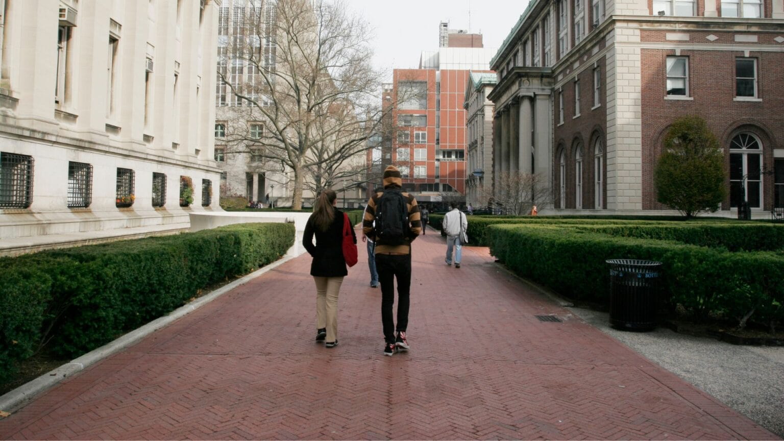 two people walking around campus