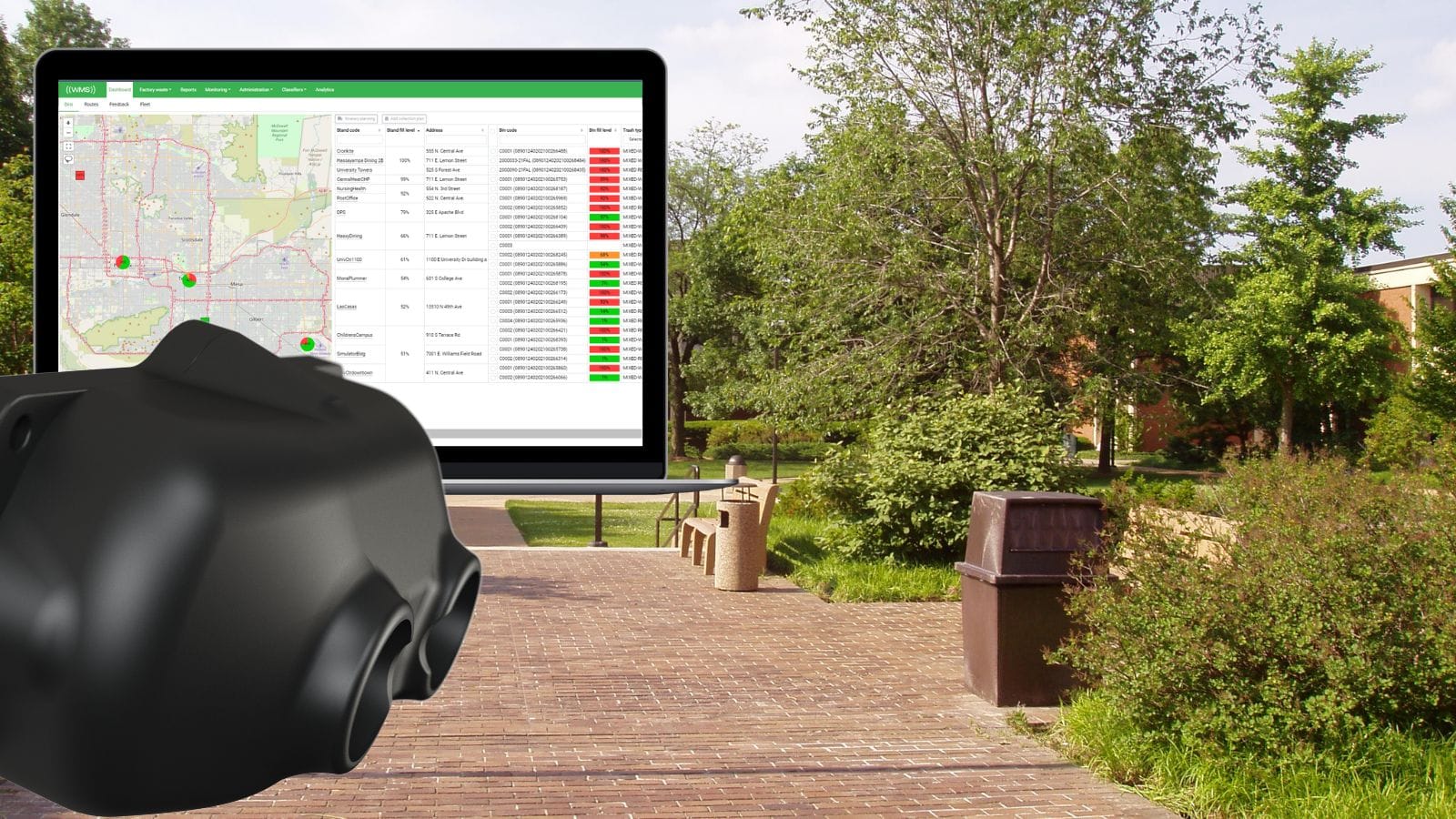 Black sensor device in the foreground with a laptop screen showing a waste management dashboard, superimposed over a campus.