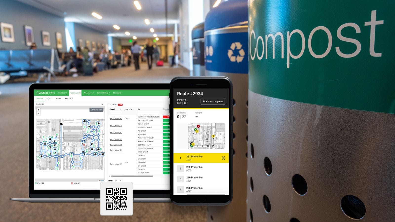 Laptop and phone display a waste tracking dashboard next to a compost bin in a busy indoor hallway.
