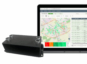 Sensor device beside a laptop showing a map-based monitoring dashboard.
