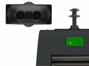 Dual-sensor device mounted above equipment with a green tag-reader panel.
