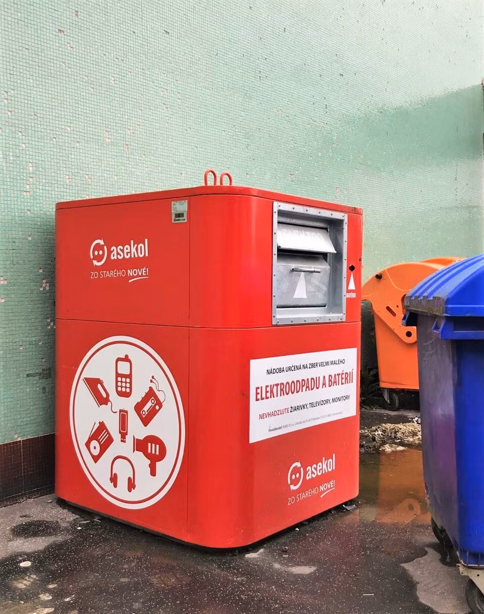 Bright red public collection bin for small electronic waste and batteries, promoting proper recycling.