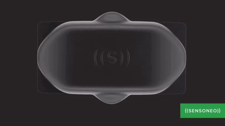 A close-up of a black sensor device with the "Sensoneo" logo.