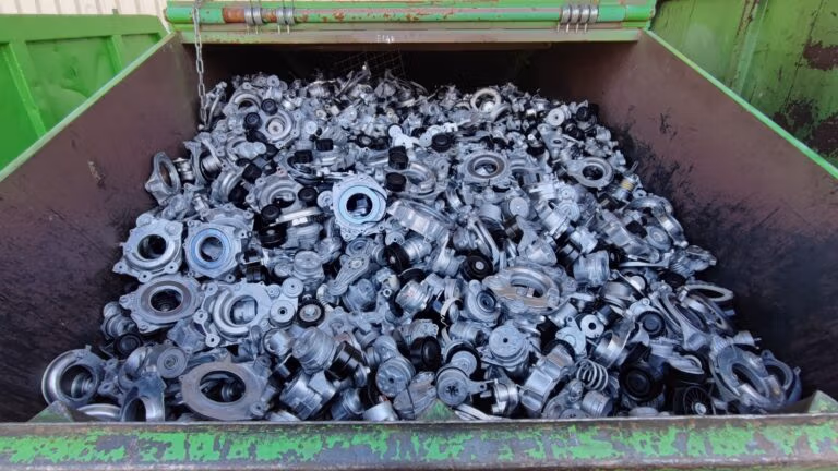 Container filled with discarded metal machine parts and components.