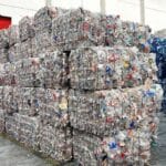 Large compressed bales of sorted plastic ready for recycling.
