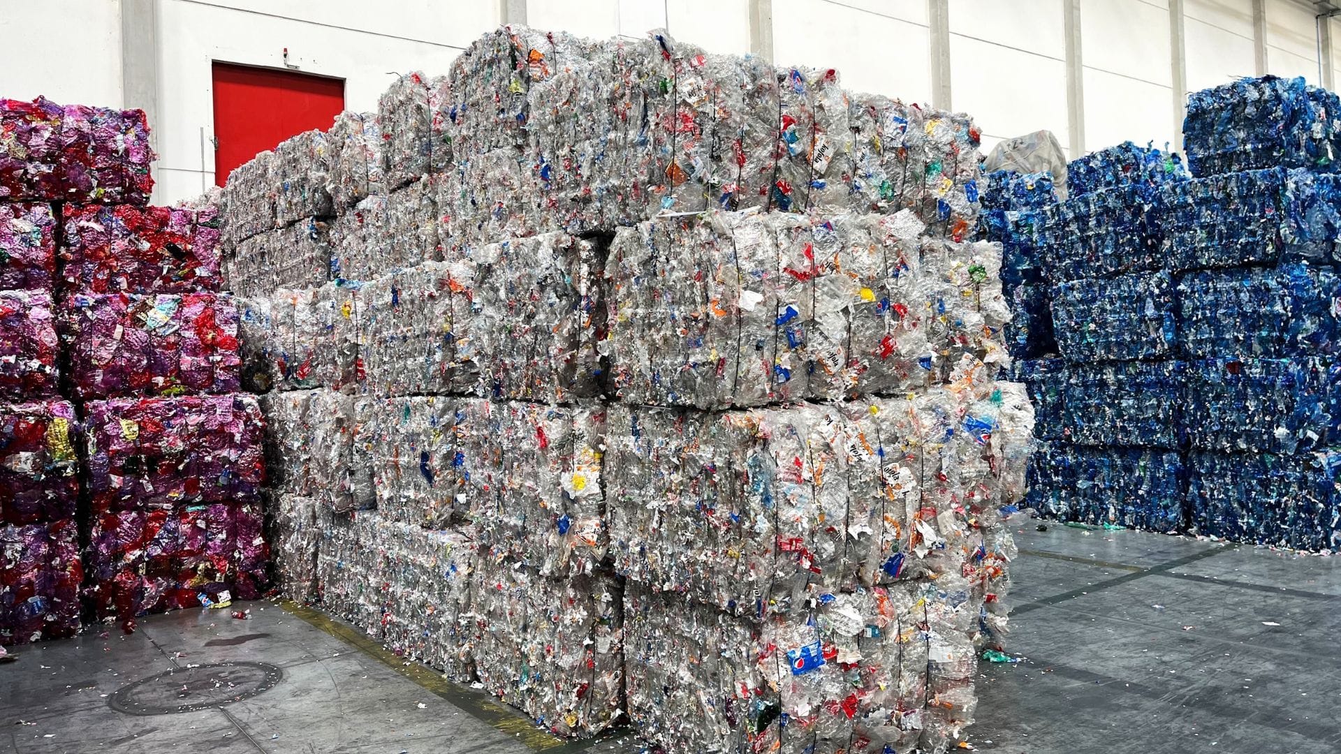 Large compressed bales of sorted plastic ready for recycling.