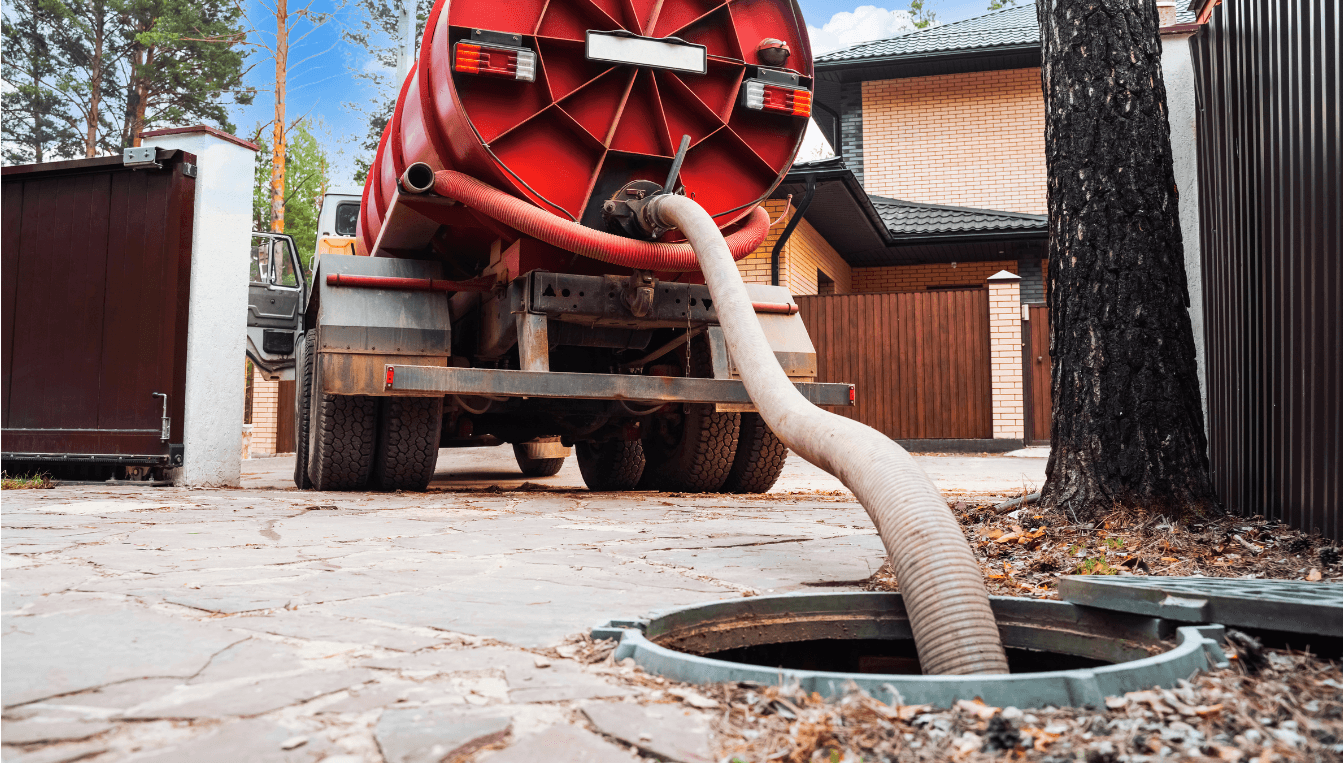 Vacuum truck pumping waste from an underground septic tank.