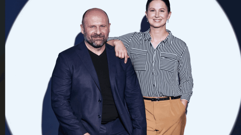 The co-founders of Sensoneo pose on stage after winning an award, the Crystal Wing.