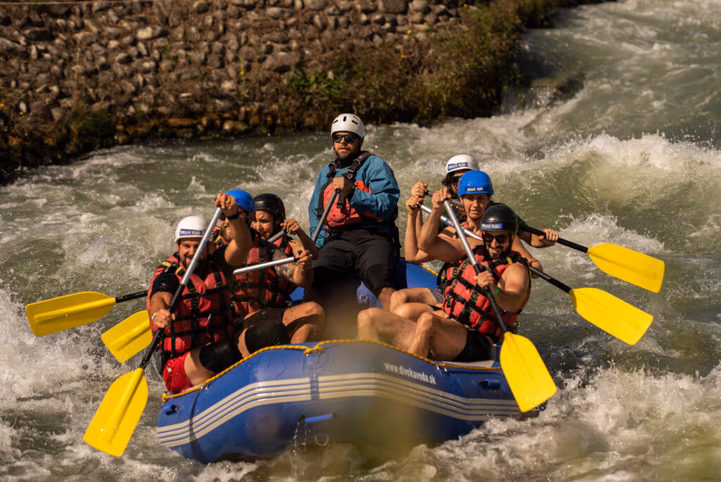 Group rafting through fast-moving river rapids.