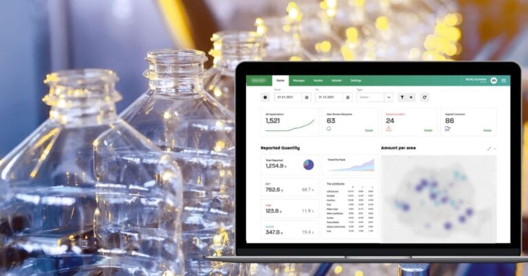 A dashboard on a laptop tracking recycling data, displayed beside empty plastic bottles.