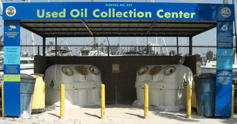 Used oil collection station with designated recycling tanks and signage.