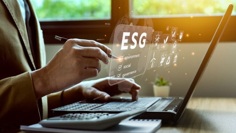 Professional reviewing ESG (environment, social, governance) data on a laptop.