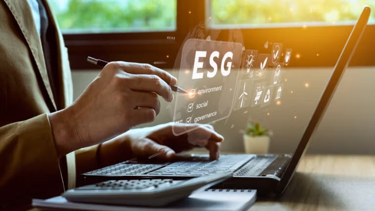 Professional reviewing ESG (environment, social, governance) data on a laptop.