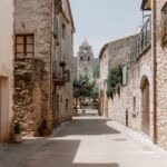 A quiet, clean street with houses with stone walls, in Mollerus Spain.