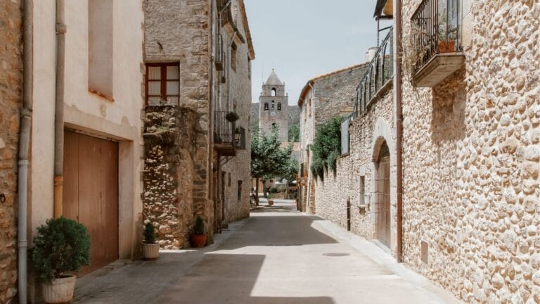 A quiet, clean street with houses with stone walls, in Mollerus Spain.