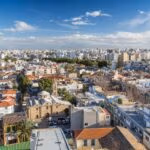 Modern cityscape blending dense urban buildings with historic architecture.