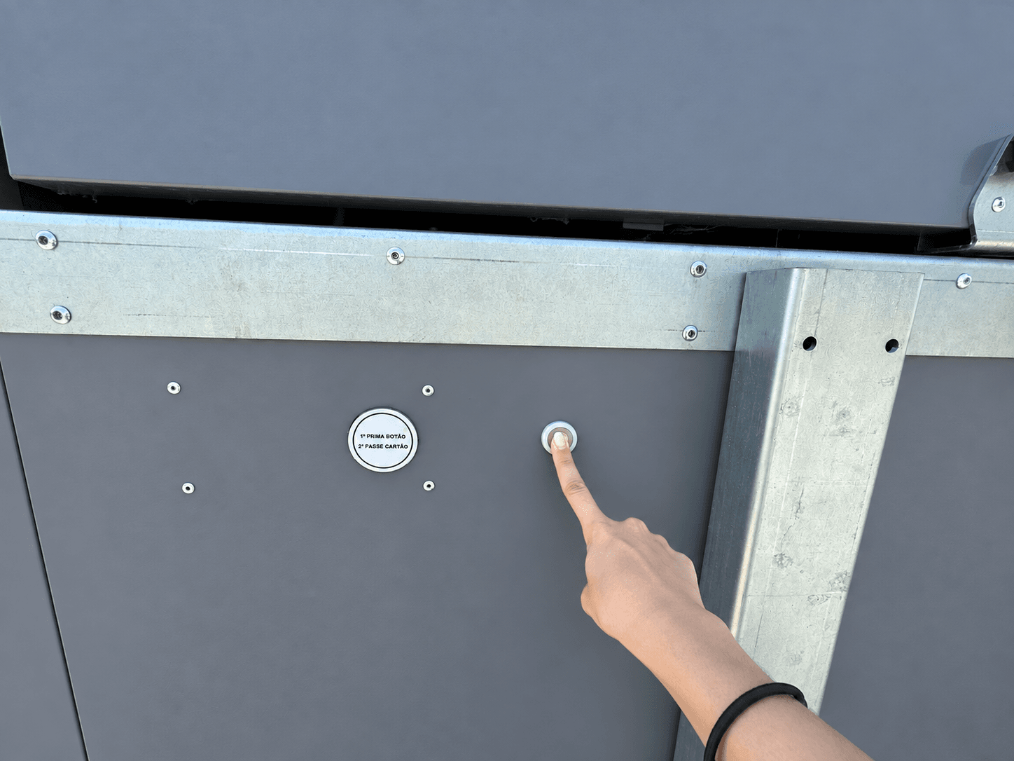 User pressing the button on a BAM smart lock in Portugal